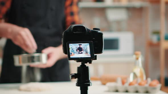 Video Camera Filming Man in Kitchen