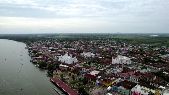 rotational drone shot of the main church and the papaloapan river in tlacotalpan, veracruz, mexico