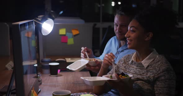 Office executives eating and discussing in a modern office