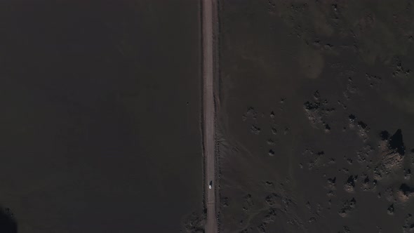 Aerial view of a car driving a desert road, Sainte Rose, Reunion.