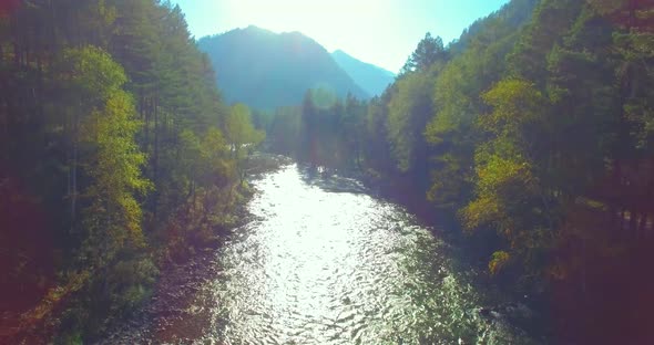 Low Altitude Flight Over Fresh Fast Mountain River with Rocks at Sunny Summer Morning.