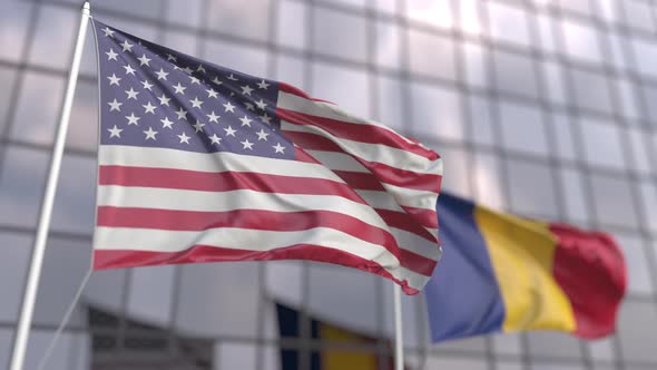 Flying Flags of the USA and Romania in Front of a Skyscraper