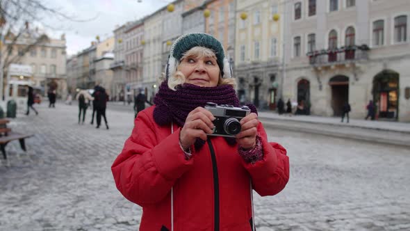 Senior Woman Grandmother Tourist Taking Pictures with Photo Camera Smiling Using Retro Device