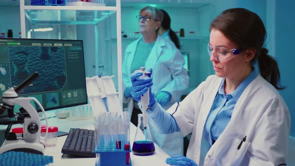 Chemist Putting Liquid Test Tube Micropipette