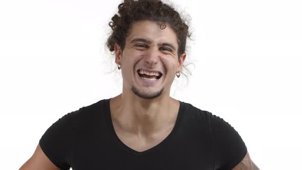 Closeup of Attractive Hispanic Man with Curly Ponytail and Beard Looking Happy Nodding in Approval