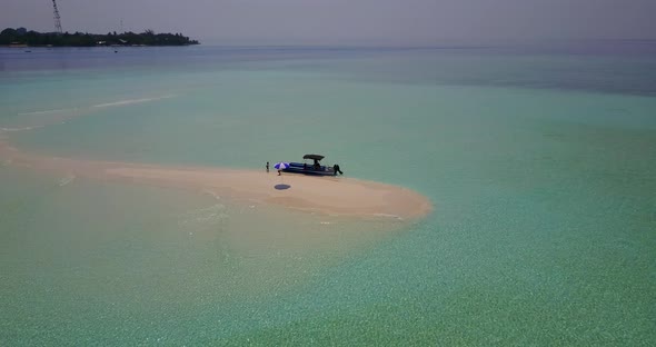 Luxury overhead tourism shot of a white paradise beach and aqua blue water background in colorful 4K