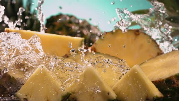 Slow Motion Shot of Pineapple and Water Splashing Through Pineapple Slices