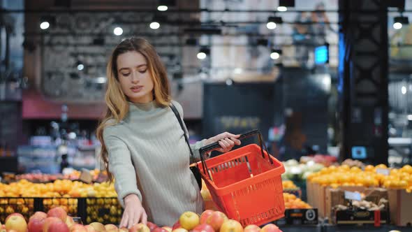 Young Business Woman Girl Buyer Client Blonde Lady Consumer Stands in Shop Near Counter with Fruits