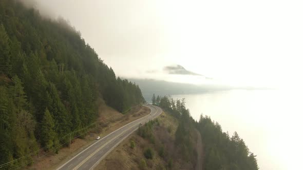 Aerial panoramic view of Sea to Sky Highway near Horseshoe Bay during a sunny winter evening before