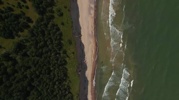 Top View: Beautiful Turquoise Baltic Sea with Waves and Sand Cliff