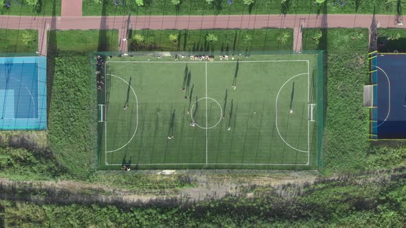 Playing Football on Football Soccer Field Top view