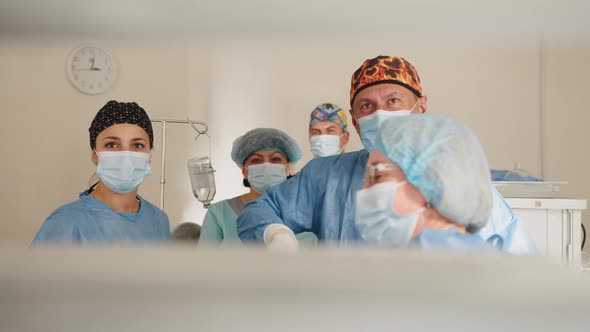 Team of Surgeons Performing Operation in Hospital