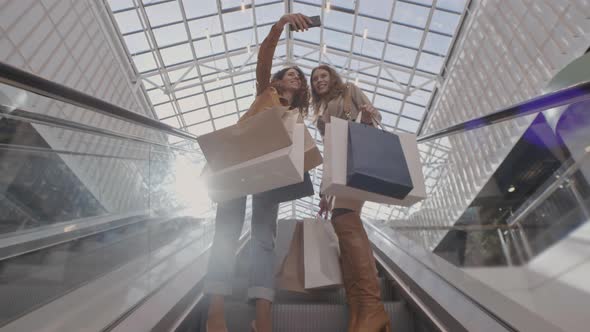 Two Women Making Selfie on Escalator