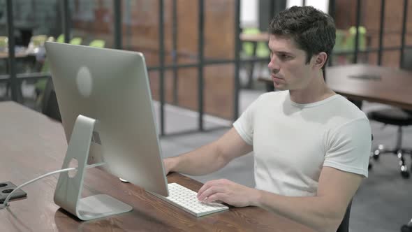 Young Man Working on Computer Online