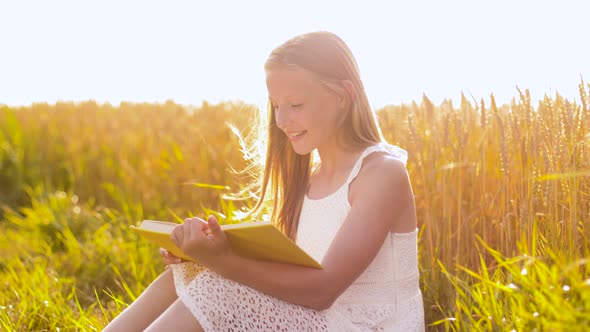 Smiling Young Girl Reading Book on Cereal Field