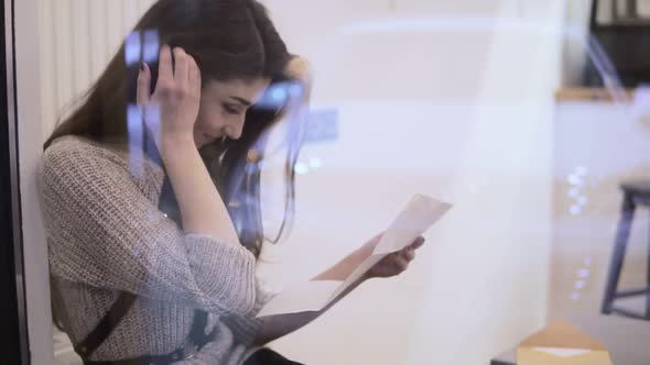 Portrait of Stylish Young Woman with Brown Hairs Reading Letter and Smiling