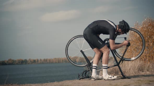 Bicyclist Repairing Wheel And Gears. Triathlete Fixes Bicycle After Breakdown. Check Wheel.