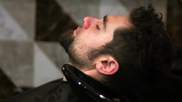 Hairdresser washing clients hair