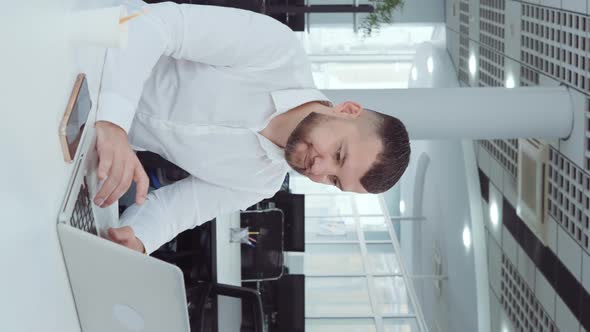 Vertical Screen Businessman Disagreeing with Partner During Online Communication