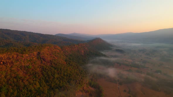 Aerial view from a drone over misty landscape on farmland. 4K