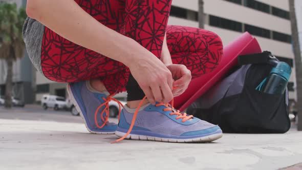 Caucasian woman tying her shoelaces