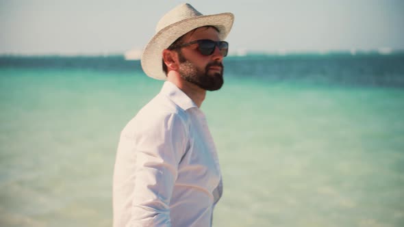 Man In Hat Walking Mediterranean Sea Beach. Cinematic Inspiration Travel Holiday Trip.Fresh Sea Bree