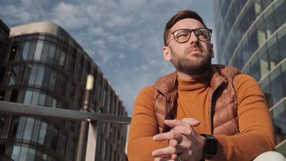 Man Taking off Glasses Outdoors