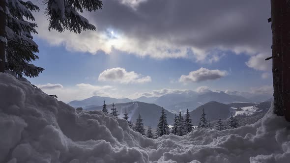 Winter snowy mountain landscape, light snow., Approaching the view from the forest