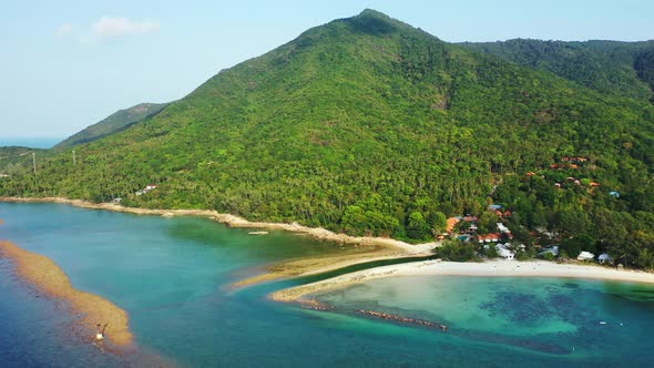 Beautiful natural palm forest on the sandy coast of Thailand island. emerald sea and small channel