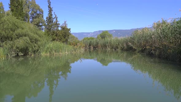 A River Surrounded By Reeds On A Flat Plain