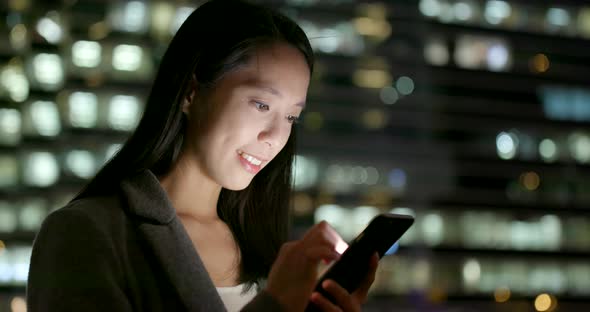 Business Woman Use of Cellphone in City at Night