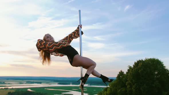 Pole Dance on Nature - Sexy Woman in Swimsuit and Colorful Knitted Crop Top Dancing on the Top of