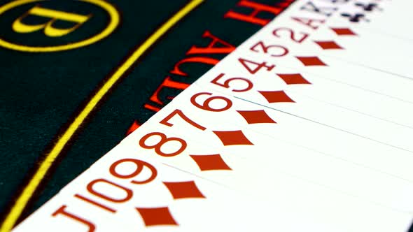 Cards Are Spread Out on Green Poker Table, Close Up
