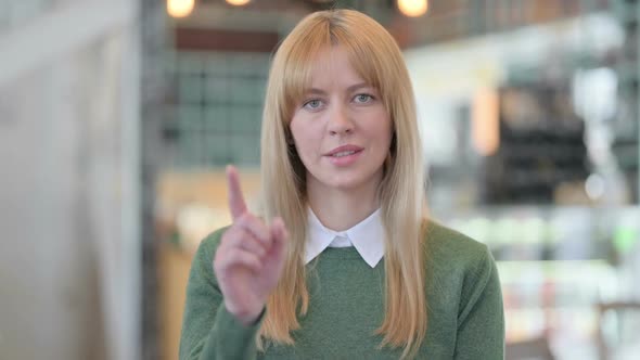 Portrait of Young Woman Showing No Sign By Finger Sign