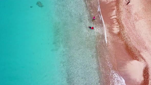 Dolly in overhead view of a group of people enjoying themselves on a hidden beach in Westpunt, Curac