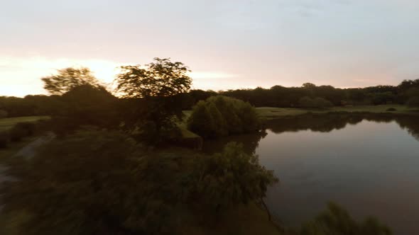 Aerial view of lake and golf course at twilight