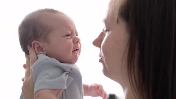 Mommy Tries to Calm the Crying Baby Shakes Him in Her Arms Dissatisfied Crying Upset Sad Newborn