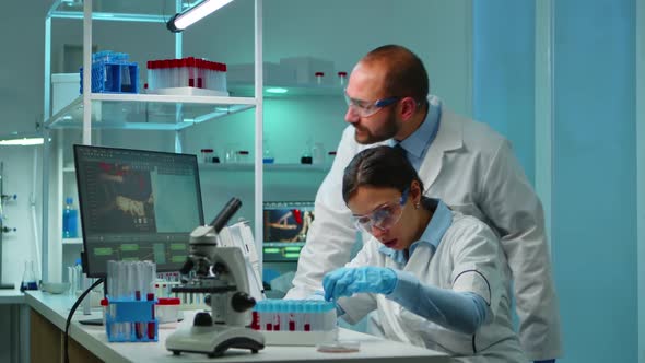 Research Chemists Working at Night Analyzing Blood Samples