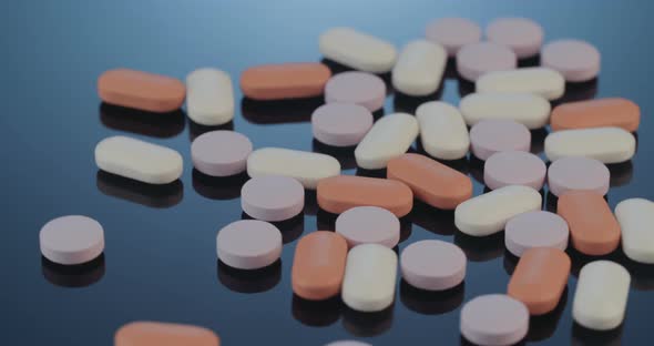 Prescription drugs - Capsules, pills, tablets on reflective background