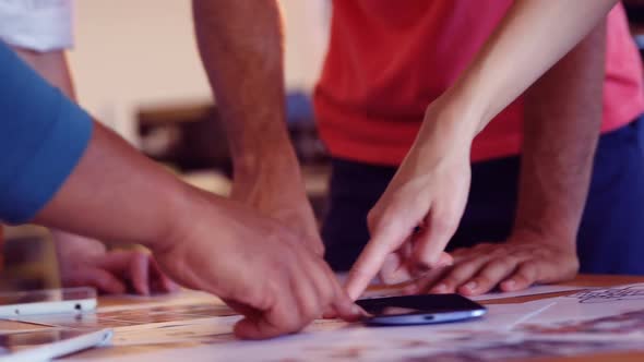 Business colleagues discussing over a document in office