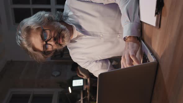 Adult Man Working On Laptop At Night