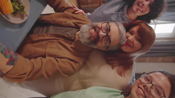 Cheerful Family Smiling at Camera while Taking Selfie at Dinner