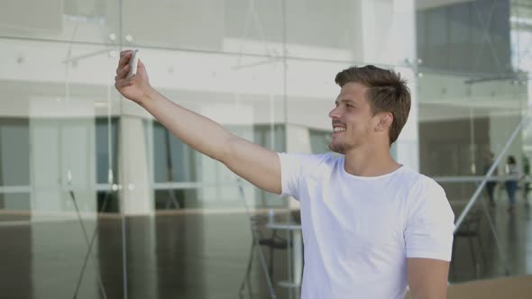 Handsome Bearded Man Recording Video with Help of Smartphone