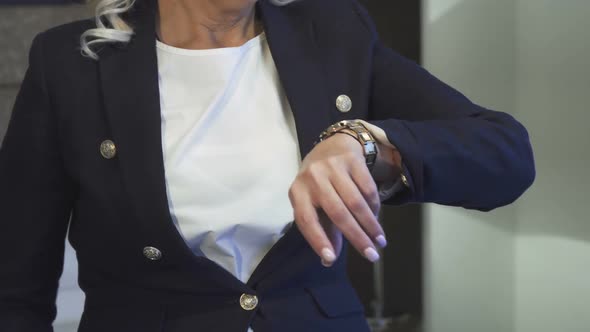 Cropped Shot of the Hand of a Woman Who Shows Her Wrist Watch