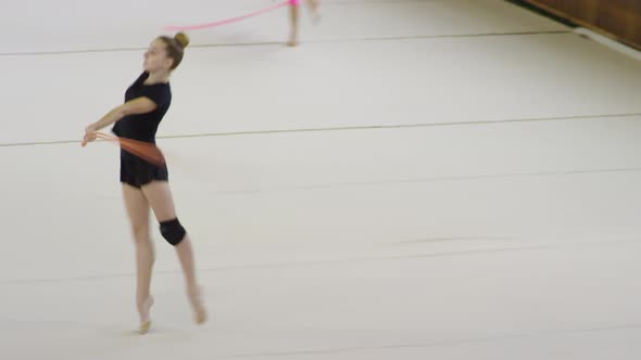 Girl Rehearsing Gymnastics Movements with Rope