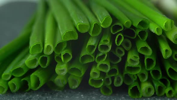 Fresh Cut Green Onions with Water Drops on Black Tray