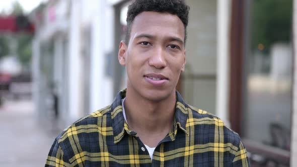 Sign of Victory By Young African Man Standing Outdoor