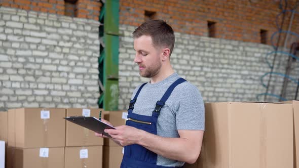 Delivery Man Writing Something to Clipboard