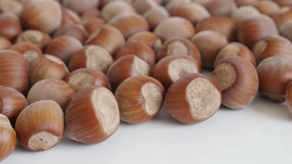 Organic hazelnuts on white background  4K 2160p 30fps UltraHD footage - Whole Corylus avellana nuts 