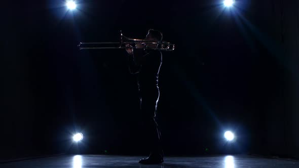 Solo Concert of Musician Playing on Trombone. Dark Studio, Spotlights